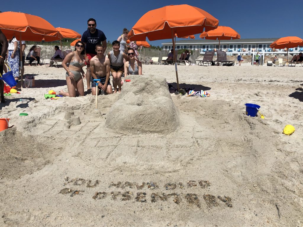 Lab members sand sculpture depicting “You have died of dysentery”.